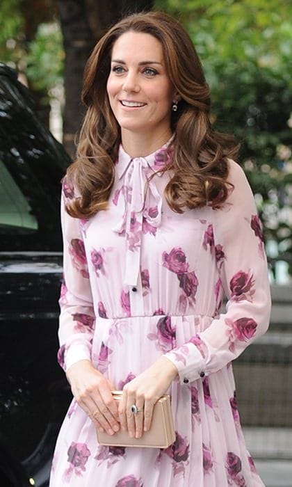 The rose-print frock, which Kate accessorized with her fave nude clutch, has a pretty tie detail at the neckline.
Photo: PA