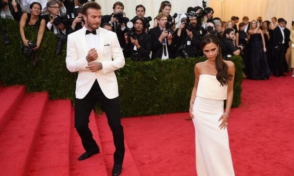 Quite possibly the most handsome couple out there, Victoria Beckham slays the red carpet as David Beckham looks on.
<br>
Photo: Getty Images