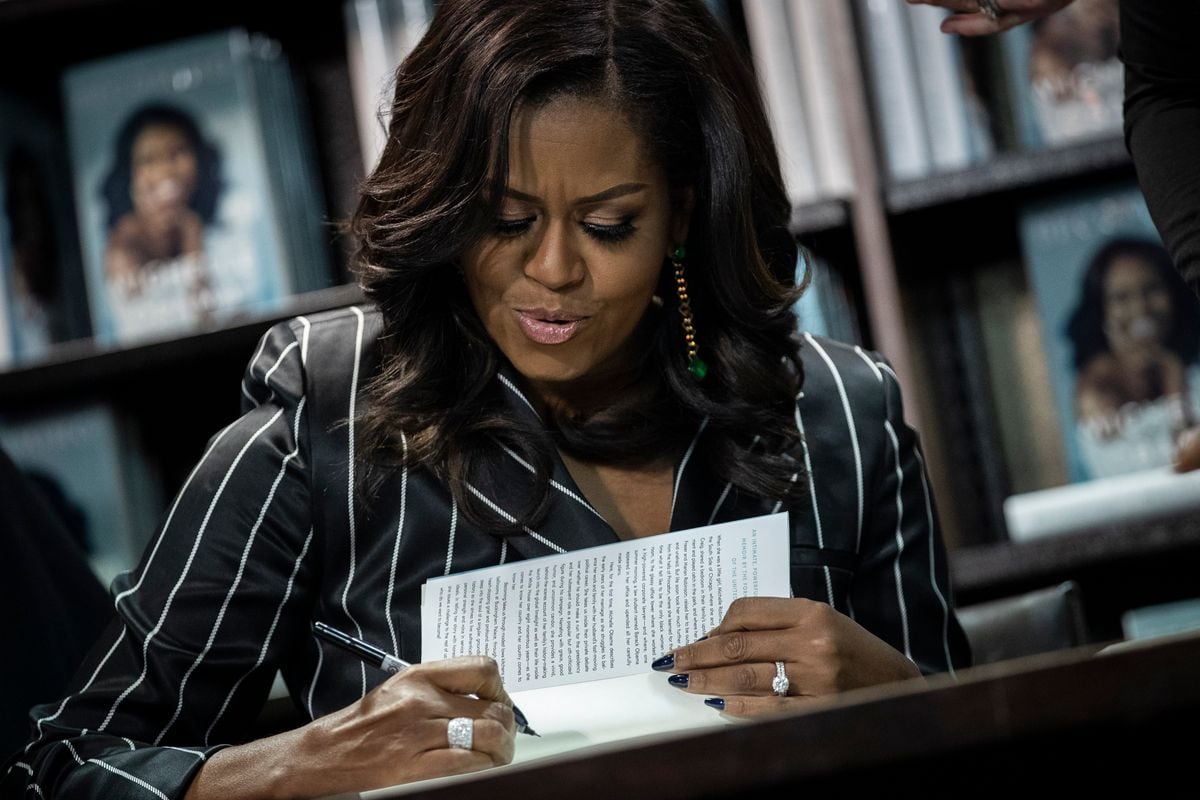 Former U.S. First Lady Michelle Obama signed copies of her new book, Becoming, during a book signing event at a Barnes & Noble bookstore on November 30, 2018, in New York City. The former first lady's memoir has sold more than 2 million copies in all formats in North America during its first 15 days on the market, according to a statement released on Friday by Penguin Random House. (Photo by Drew Angerer/Getty Images)