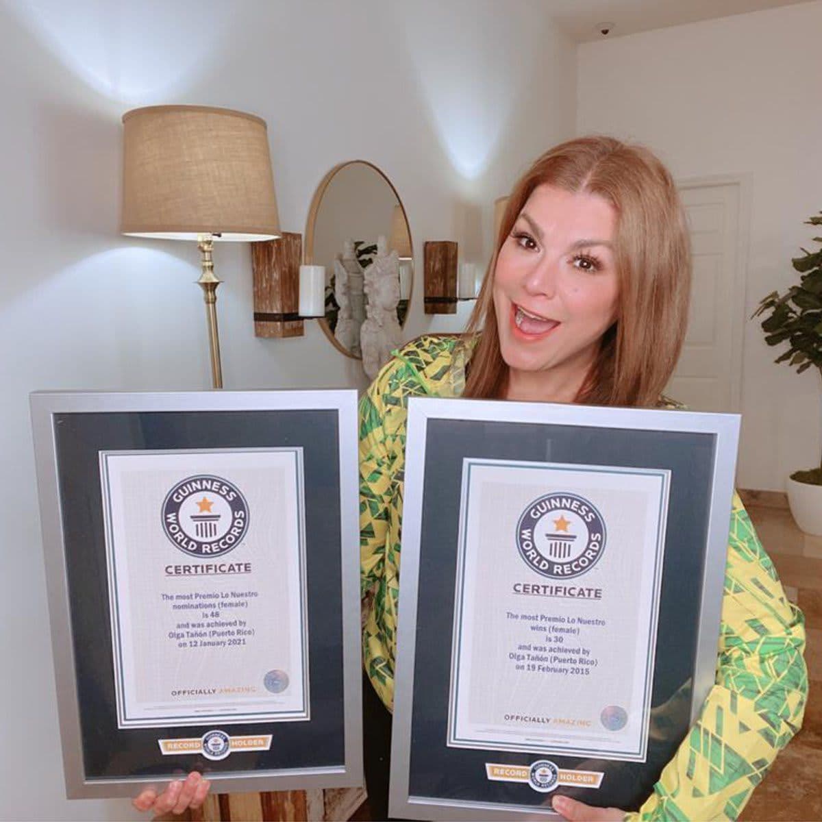 Olga Tañón holding her third GUINNESS WORLD RECORDS title for the most Premio Lo Nuestro nominations