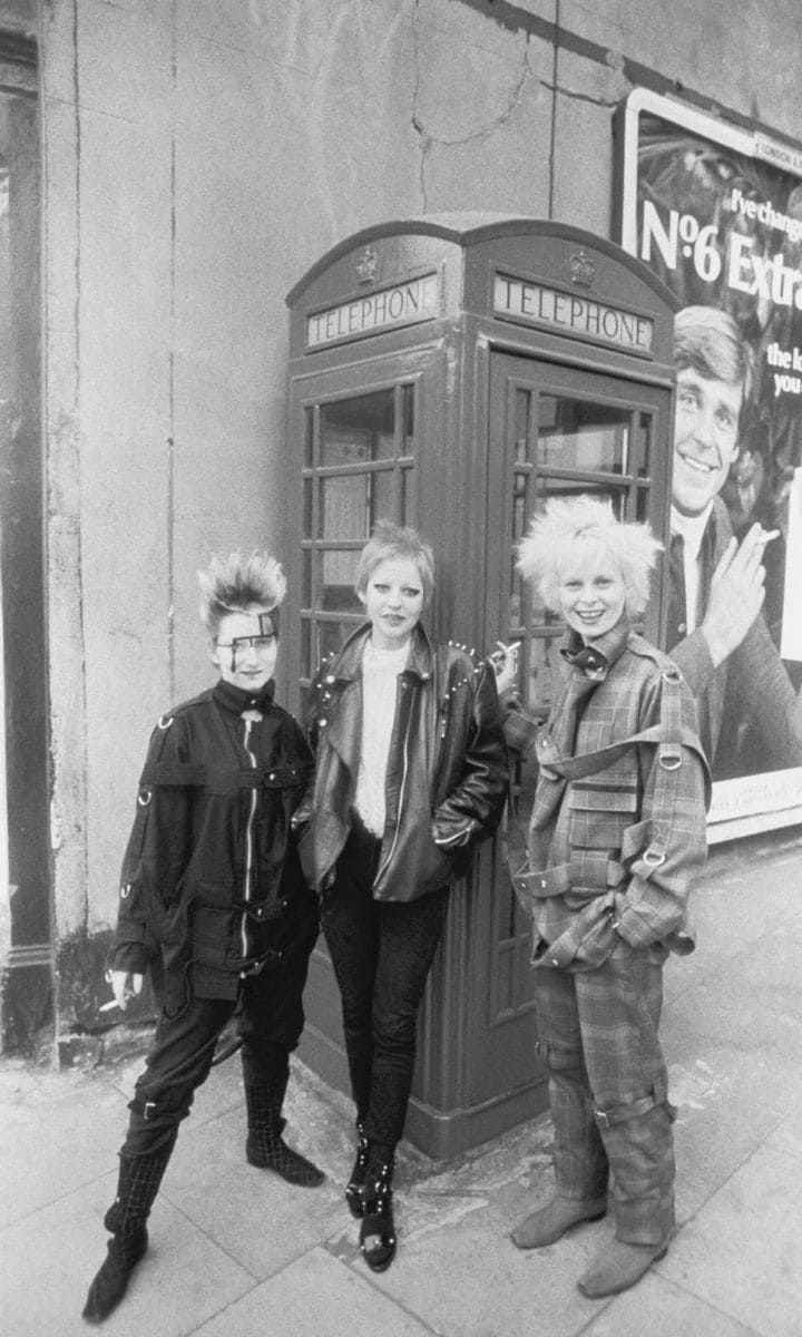 Fashion designer Vivienne Westwood (in plaid) with Jordan (L) and friend pose against a telephone box on a London street on April 12, 1977.