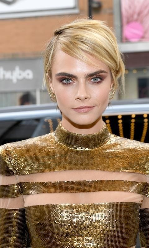 Cara Delevingne in a gold top