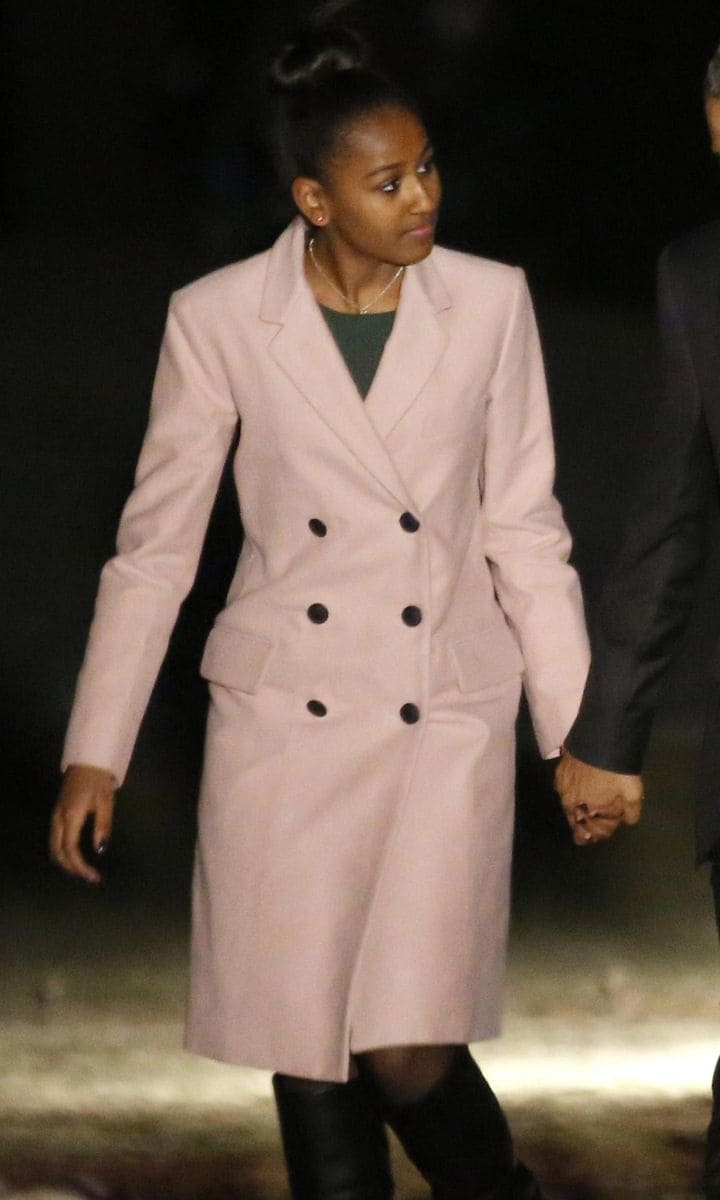 Sasha Obama wearing pink coat and black boots