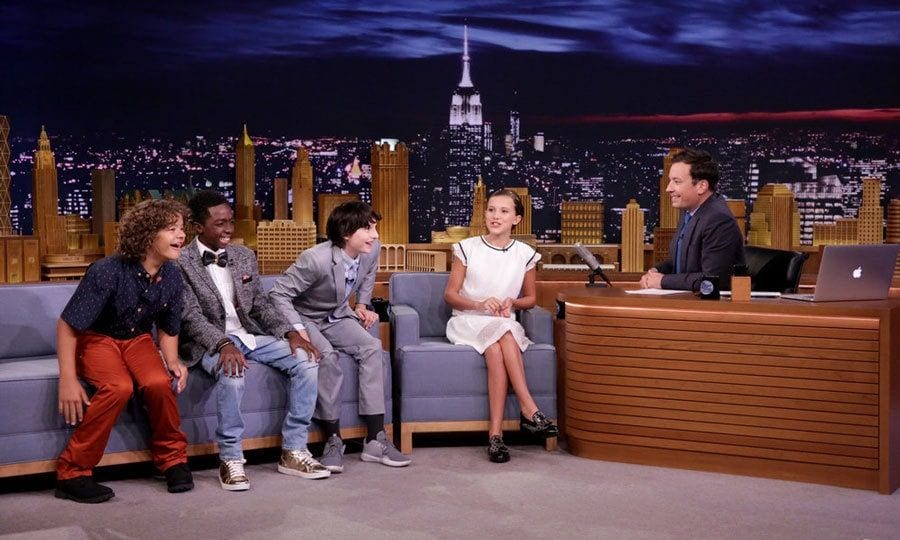 While visiting the <i>Tonight Show</i> in New York City, 12-year-old budding star <b>Millie Brown</b> opened up to host Jimmy Fallon about having her first kiss with co-star Finn Wolfhard on their hit Netflix show, <i>Stranger Things</i>.
<br>
"It was your first kiss, right?" the host asked, to which she responded, "Yup." She added, "It was great."
<br>
The pair revealed that Finn went through two packs of Tic Tacs prior to filming the scene. The show's creators, the Duffer brothers, "didn't help" make it any less awkward by sending them kiss-y face emojis. After the scene Millie admitted she said, "Kissing sucks," while she said Finn was like, "It wasn't too bad."
</br><br>
Photo: Andrew Lipovsky/NBC