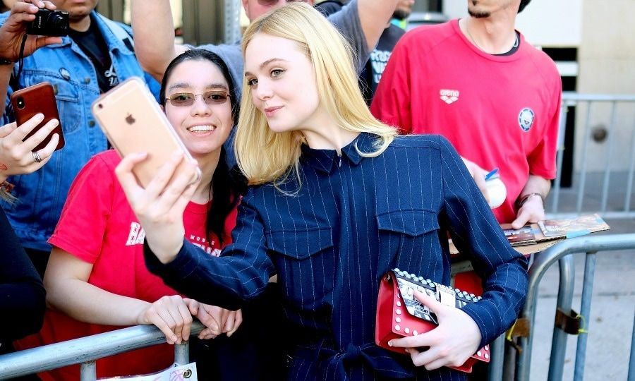 But first, let's take a selfie! Dakota's sister Elle Fanning looked fabulous in a pinstripe jumpsuit while greeting a fan at the premiere of her film <i>Galveston</i> at the Paramount Theatre on March 10.
Photo: Matt Winkelmeyer/Getty Images for SXSW