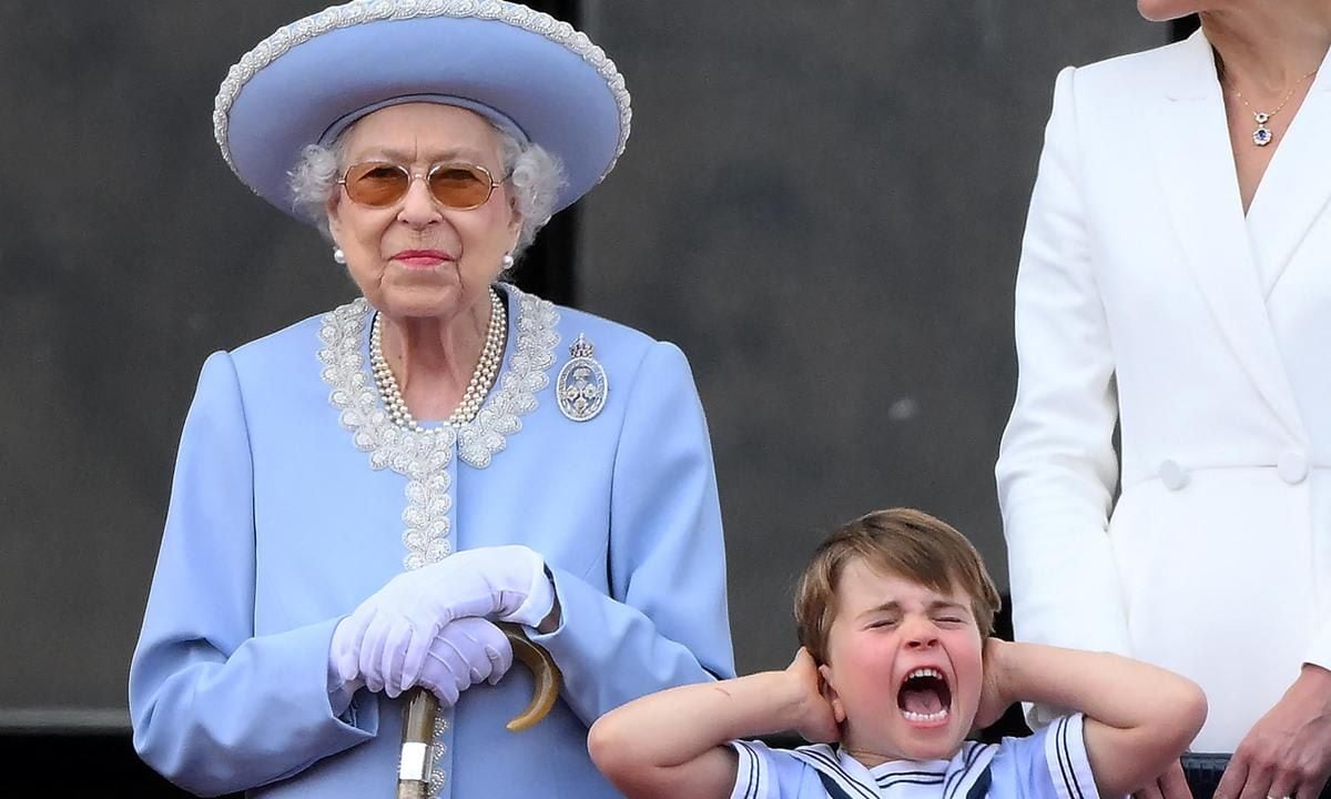 Too loud? The Duke and Duchess of Cambridge's youngest son covered his ears while on the balcony of Buckingham Palace during the flypast.