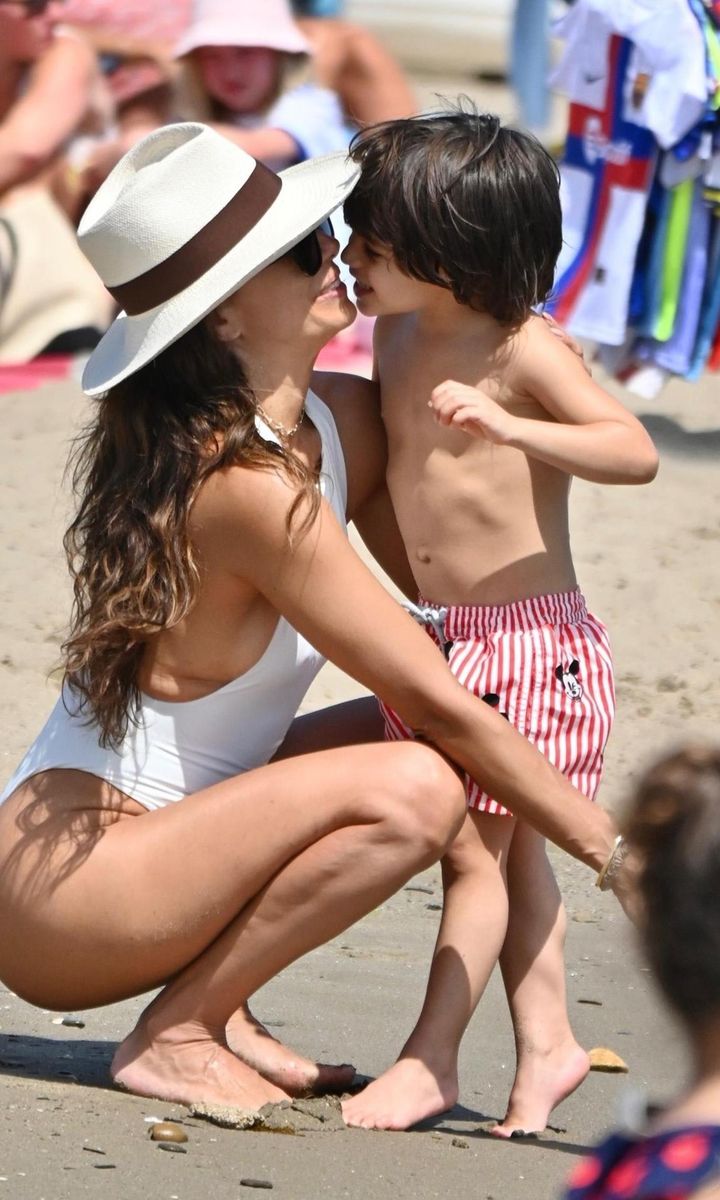 American actress Eva Longoria wows in a white swimsuit while pictured relaxing on the beach