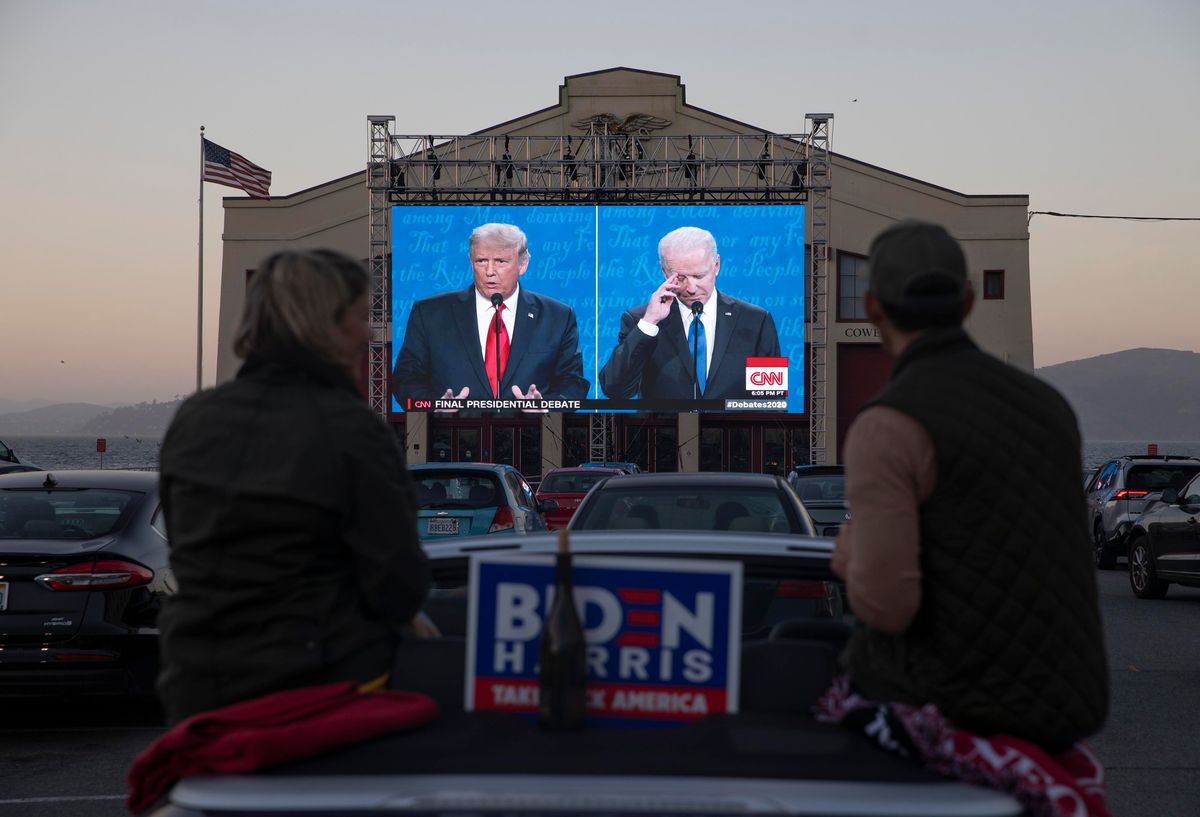 People watch the final U.S. presidential debate between President Donald Trump and Democratic candidate Joe Biden outside Cowell Theater on October 22, 2020 in San Francisco, California. 