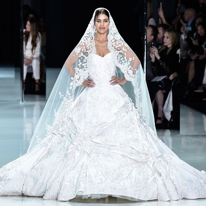 <a href="https://us.hellomagazine.com/tags/1/fashion-week/"><strong>Paris Haute Couture Fashion Week</strong></a> isn't just the place to find the exclusive gowns that you might see worn by stars on the <a href="https://us.hellomagazine.com/tags/1/oscars/"><strong>Academy Awards</strong></a> red carpet it's also where you will see some of the most beautiful dream wedding dresses ever imaginable floating down the runway. Whether you are planning your wedding and need some inspiration, or just love bridal fashion, scroll through to see the fairytale gowns by designers including Chanel, Ralph & Russo and celebrity favorite Elie Saab.
<B>RALPH & RUSSO</B>
This lavish look was presented by London-based Ralph & Russo, who were shot into the royal spotlight when <a href="https://us.hellomagazine.com/tags/1/prince-harry/"><strong>Prince Harry</strong></a>'s fiancee <a href="https://us.hellomagazine.com/tags/1/meghan-markle/"><strong>Meghan Markle</strong></a> chose one of their haute couture designs for her official engagment photos. This spectacular hand-embroidered bridal confection is embellished with 3D Swarovski jeweled leaves, silk floss flowers and intricate metallic silk threadwork.
Photo: Getty Images