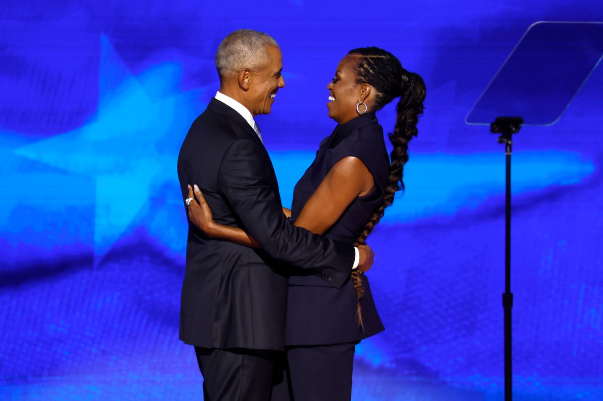 Former U.S. President Barack Obama (L) greets former first lady Michelle Obama as he arrives to speak on stage during the second day of the Democratic National Convention at the United Center on August 20, 2024 in Chicago, Illinois. Delegates, politicians, and Democratic Party supporters are gathering in Chicago, as current Vice President Kamala Harris is named her party's presidential nominee. The DNC takes place from August 19-22. (Photo by Chip Somodevilla/Getty Images)