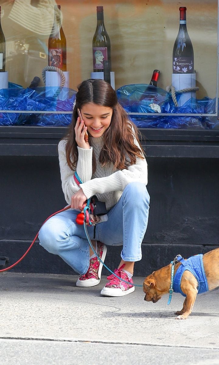 Suri Cruise seen playing with her puppies while out and about in New York City