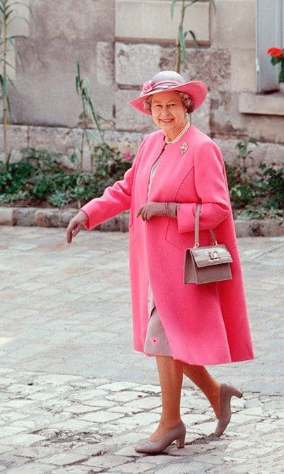 During a visit to Blois in France, The Queen wore a pink and taupe outfit designed by Ian Thomas in 1992.
<br>
Photo: Getty Images