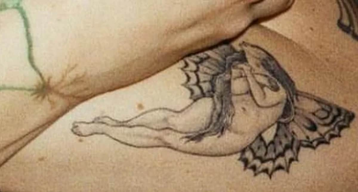 A woman with butterfly wings on her forearm