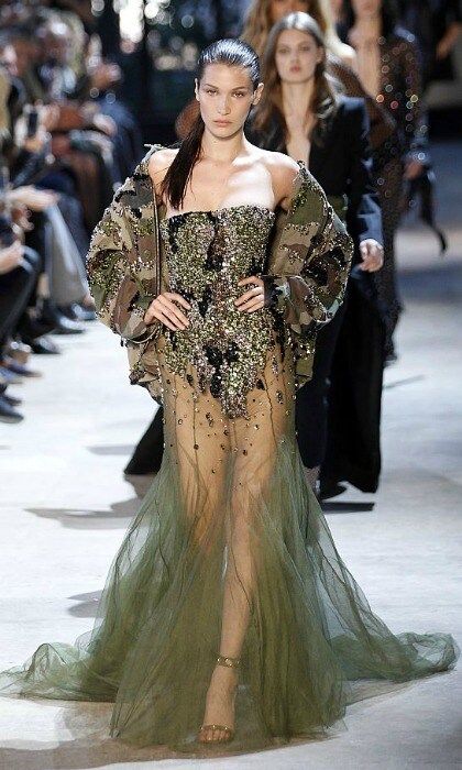 <a href="https://us.hellomagazine.com/tags/1/Bella-Hadid" target="_blank" style="font-weight: bold;">Bella Hadid</a> owned the Alexandre Vauthier runway modeling an embellished camouflage-colored gown with a sheer skirt that showcased her trim legs.
<br>
Photo: Thierry Chesnot/Getty Images