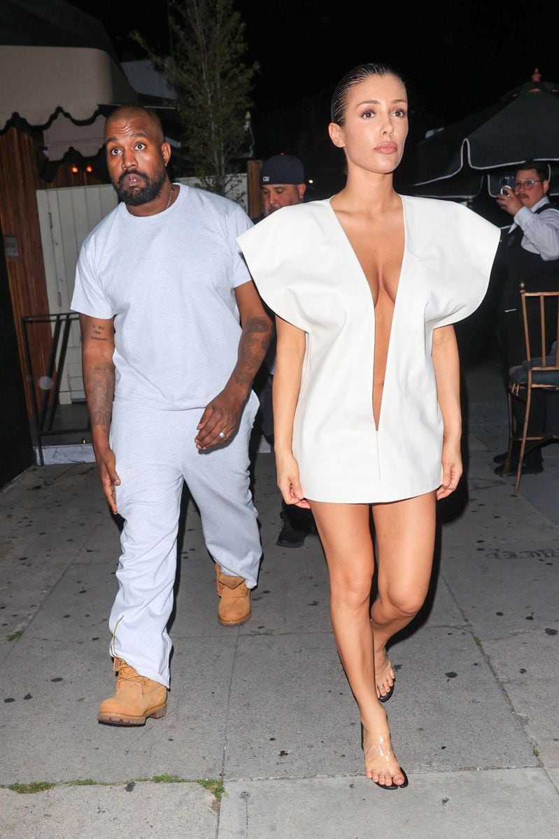 Kanye West & wife Bianca Censori match in all white ensembles at the Ty Dolla $ign birthday party in West Hollywood. 