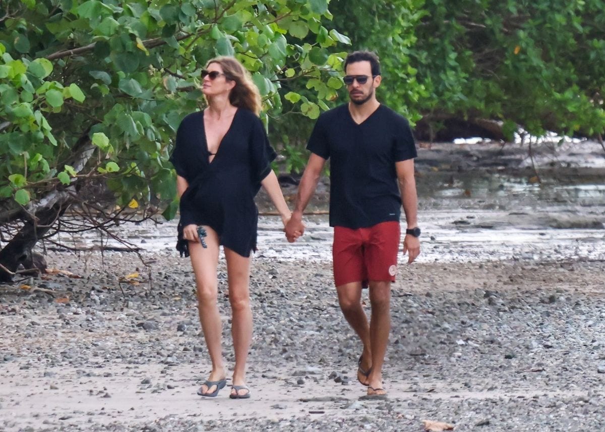 Gisele Bündchen and Joaquim Valente share a romantic sunrise stroll along the beach in Costa Rica, joined by their loyal dog. 