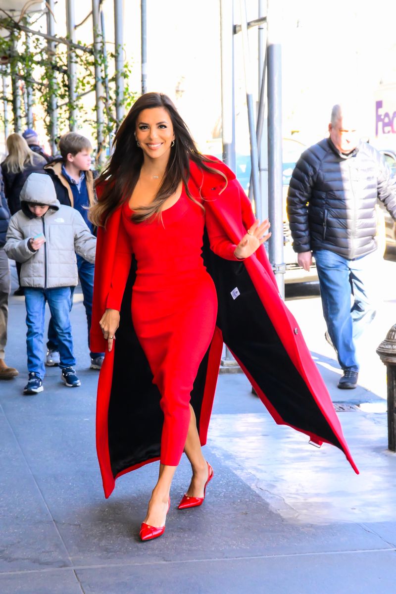 Longoria matched the dress with red accessories