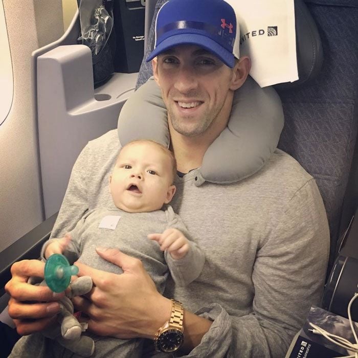 Homeward bound! After sweeping up six new Olympic medals in Rio, Michael headed back to the states with his happy baby boy on his lap.
<br>
Photo: Instagram/@nicole.m.johnson