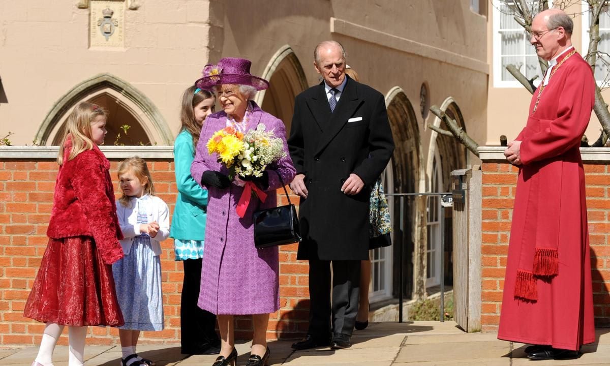 Children give flowers to Britain's Queen