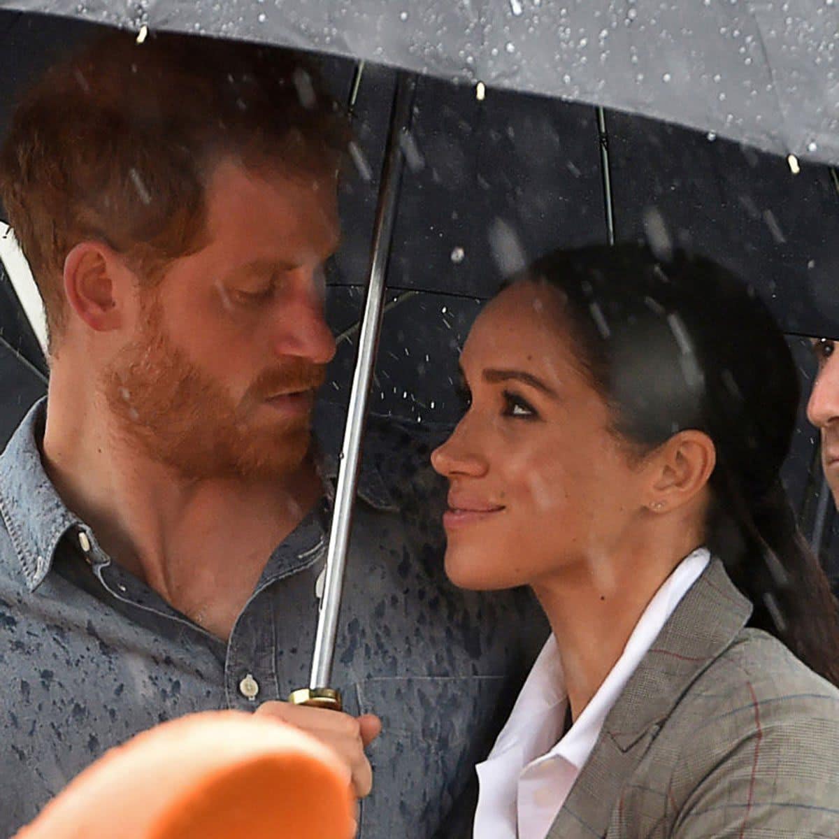 Harry and Meghan Markle under the same umbrella