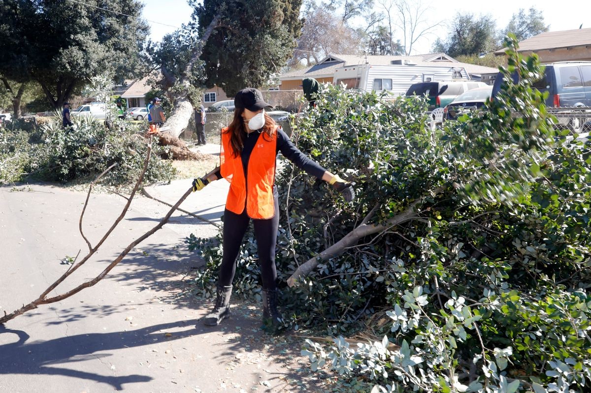 Eva Longoria clearing debris from an affected neighborhood