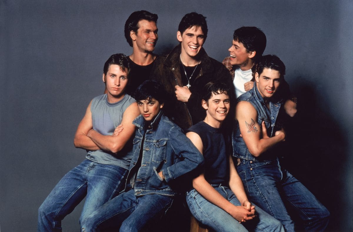 American actors Patrick Swayze, Matt Dillon, Rob Lowe, Emilio Estevez, Ralph Macchio, Thomas C. Howell, and Tom Cruise on the set of 'The Outsiders'