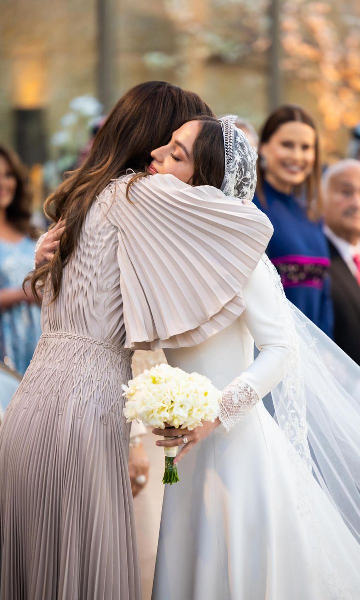 Rania, who was seen dabbing her eyes during the wedding, shared a hug with her daughter after the ceremony.