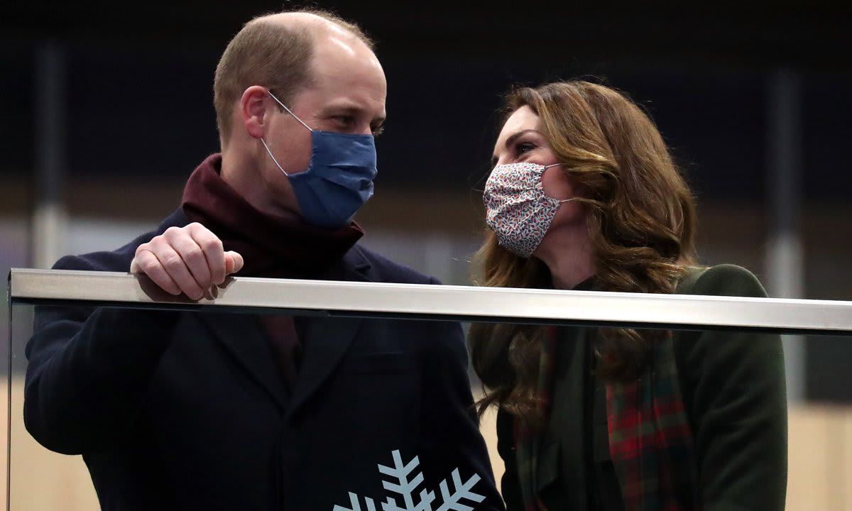 A mask couldn't hide the couple's look of love at the train station in London.