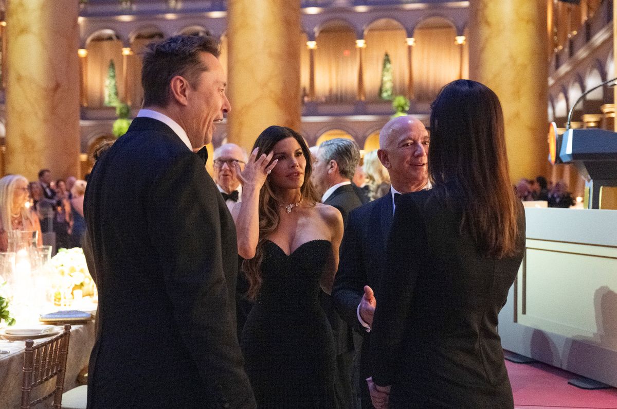 Elon Musk, Lauren Sanchez, Jeff Bezos talk before US President-elect Donald Trump speaks at a candlelight dinner at the National Building Museum 