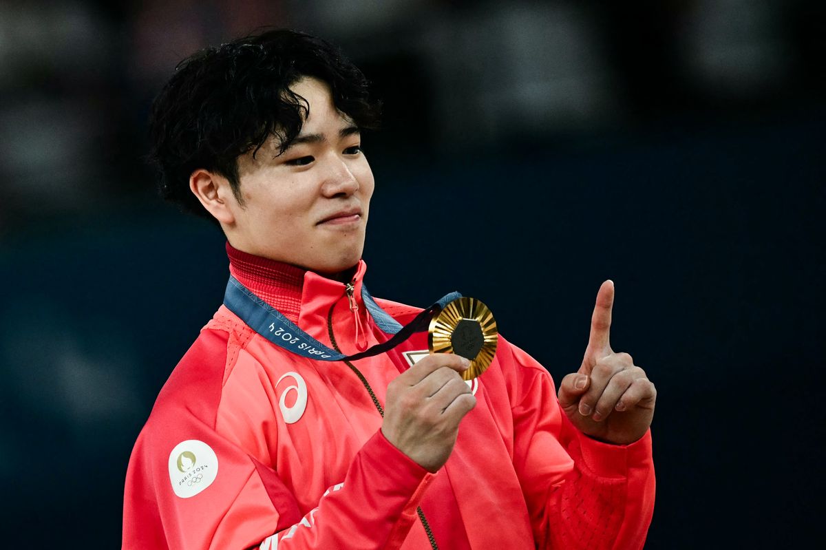 Japan's Shinnosuke Oka celebrates with his gold medal during the podium ceremony for the artistic gymnastics men's all-around final during the Paris 2024 Olympic Games at the Bercy Arena in Paris, on July 31, 2024. (Photo by Loic VENANCE / AFP) (Photo by LOIC VENANCE/AFP via Getty Images)