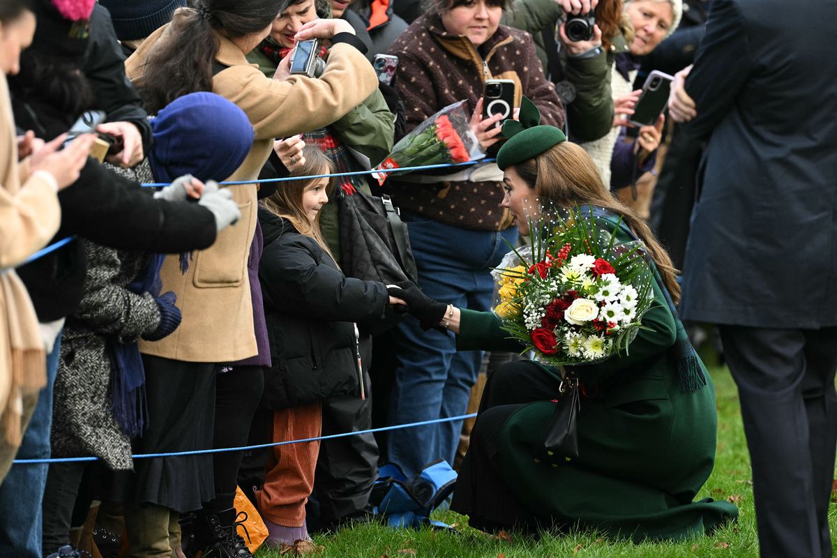 Britain's Catherine, Princess of Wales shakes hand with a young wellwisher after attending the Royal Family's traditional Christmas Day service at St Mary Magdalene Church in Sandringham, Norfolk, eastern England, on December 25, 2024. (Photo by Oli SCARFF / AFP) (Photo by OLI SCARFF/AFP via Getty Images)