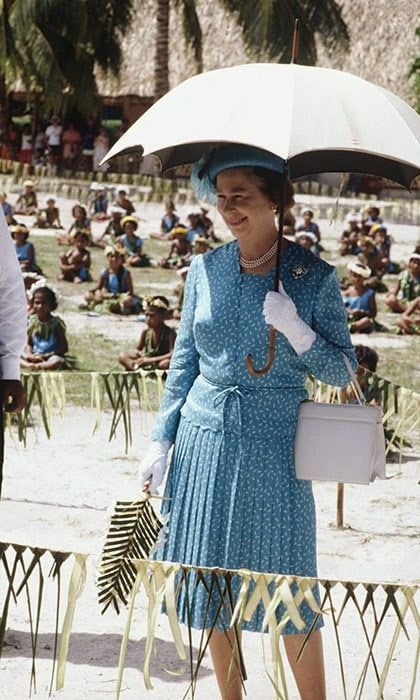 The Queen blocked the sun with a stylish weather accessory outside of the Princess Margaret Hospital in Funafuti, Tuvalu in 1982.
<br>
Photo: Getty Images