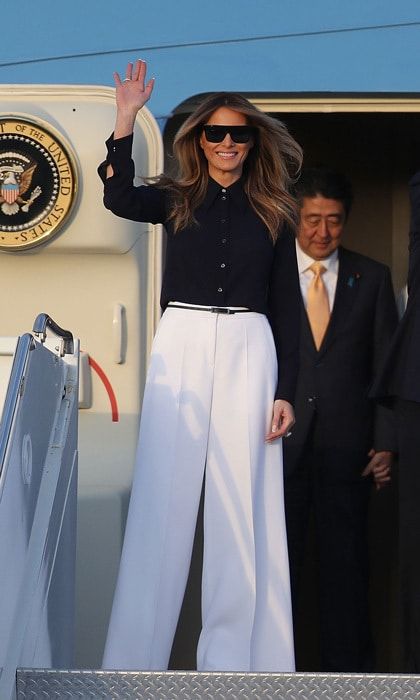 First Lady Melania Trump disembarked Air Force One with Japanese Prime Minister Shinzo Abe at the Palm Beach International Airport wearing high-waisted, white wide-legged Michael Kors pants paired with a black button-front blouse.
Photo: Joe Raedle/Getty Images