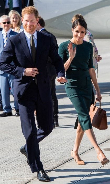 Kicking off the couple's first overseas tour earlier in the day, Meghan wore a fitted green top by one of her favourite designers Givenchy. She teamed it with a co-ordinating skirt that featured side pockets and an on-trend mid-length cut. she accessorised the design with a Strathberry Mid tote in tan, and matching court shoes.
Photo: Getty Images