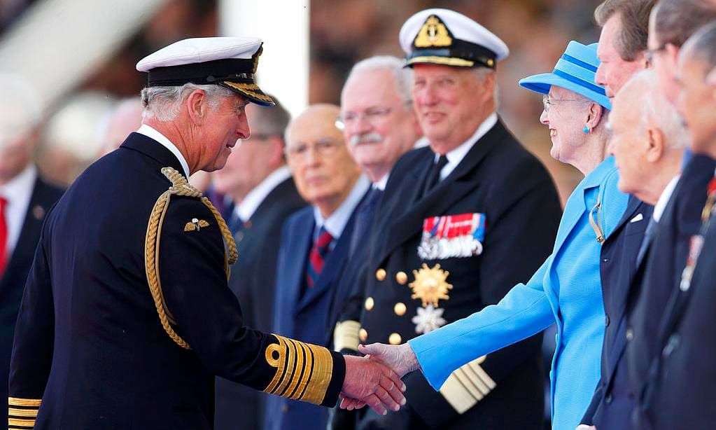 Prince Charles shakes hands with Queen Margrethe of Denmark in France