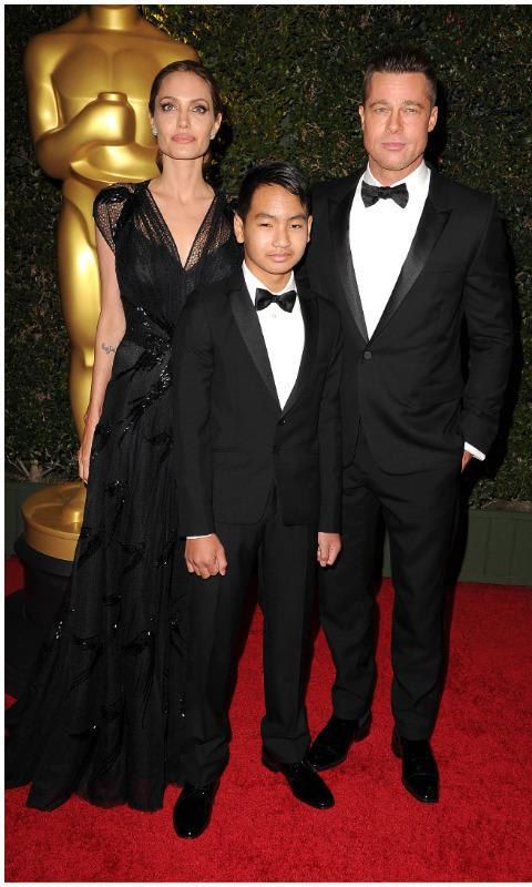 Maddox with Angelina Jolie and Brad Pitt at an awards show