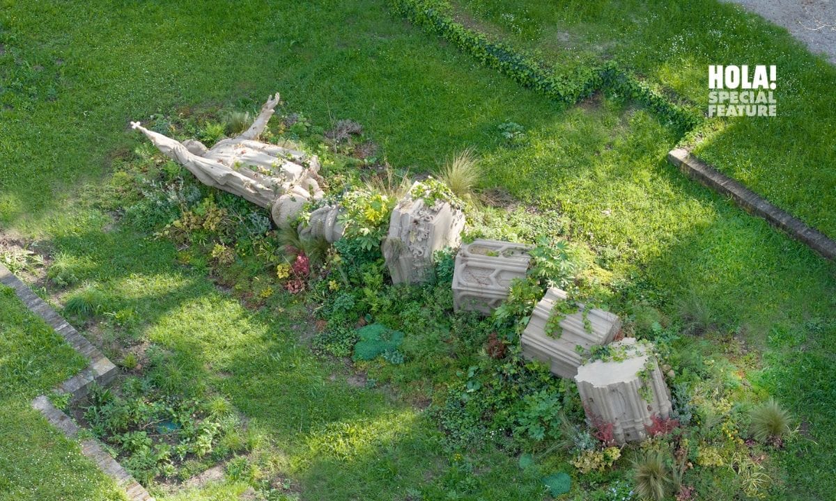 Iván Argote's artwork Descanso is an anti-monument that challenges us to rethink paradigms. It replicates Madrid's Christopher Columbus statue, toppled and overtaken by vibrant weeds and plants—both local and migrant—creating a colorful, harmonious scene of decay.