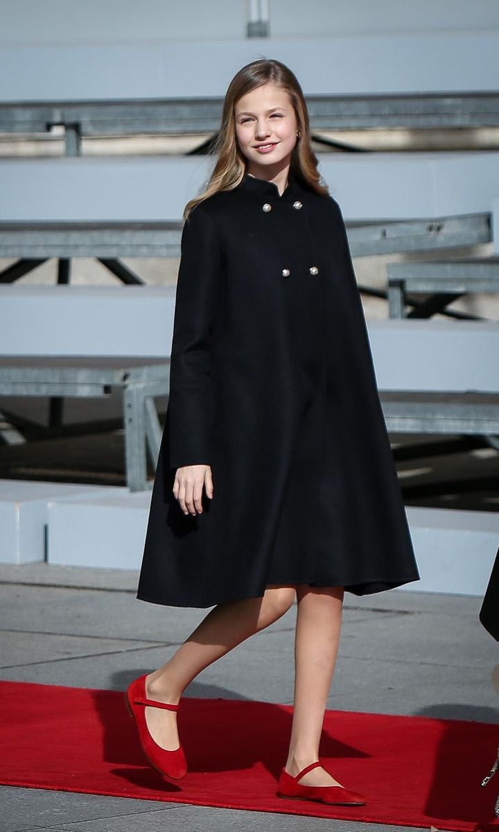 Princess Leonor stepped out in a black swing coat, which she teamed with red flats that matched her tweed outfit.