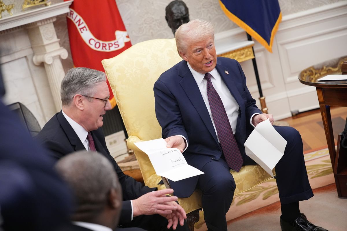 WASHINGTON, DC - FEBRUARY 27: British Prime Minister Keir Starmer (L) presents a letter from King Charles III to U.S. President Donald Trump as the two meet in the Oval Office at the White House on February 27, 2025 in Washington, DC. Starmer is on his first visit to Washington since President Trump returned to the White House. Starmer's trip comes shortly after he announced an increase in UK defense spending, ostensibly as a signal to Trump that the UK is prepared to bolster Europe's security, and as he aims to broker a fair peace deal for Ukraine amid Trump's warming relations with Russia. (Photo by Andrew Harnik/Getty Images)