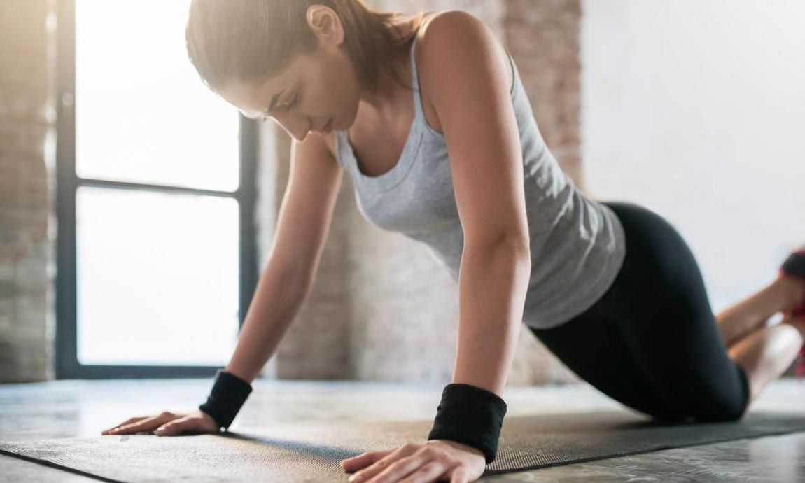 Woman does push ups using the knees as support