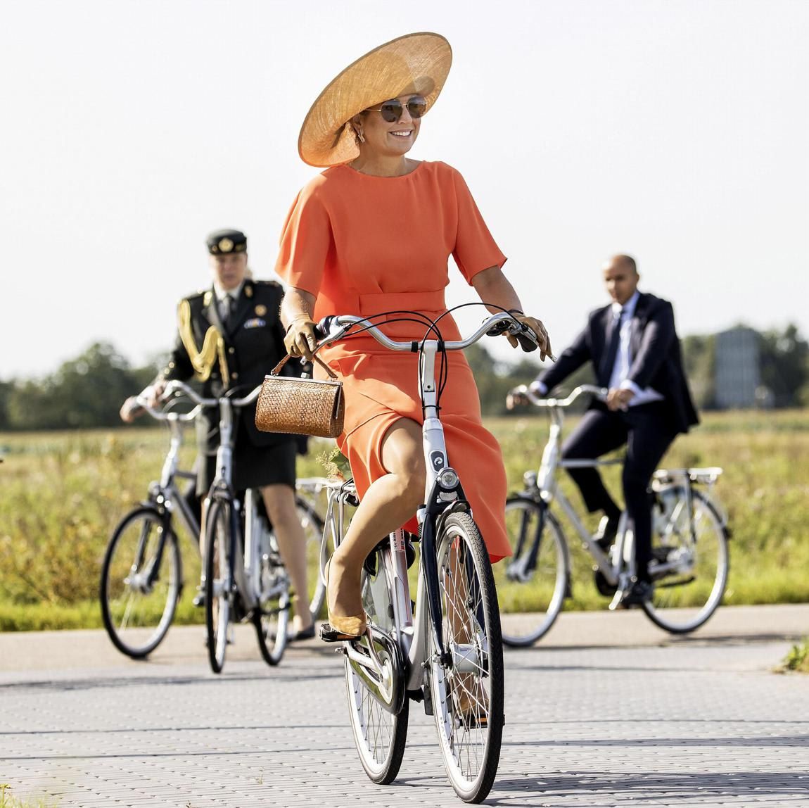 Queen Maxima wore a dress and heels while bike riding on Sept. 17