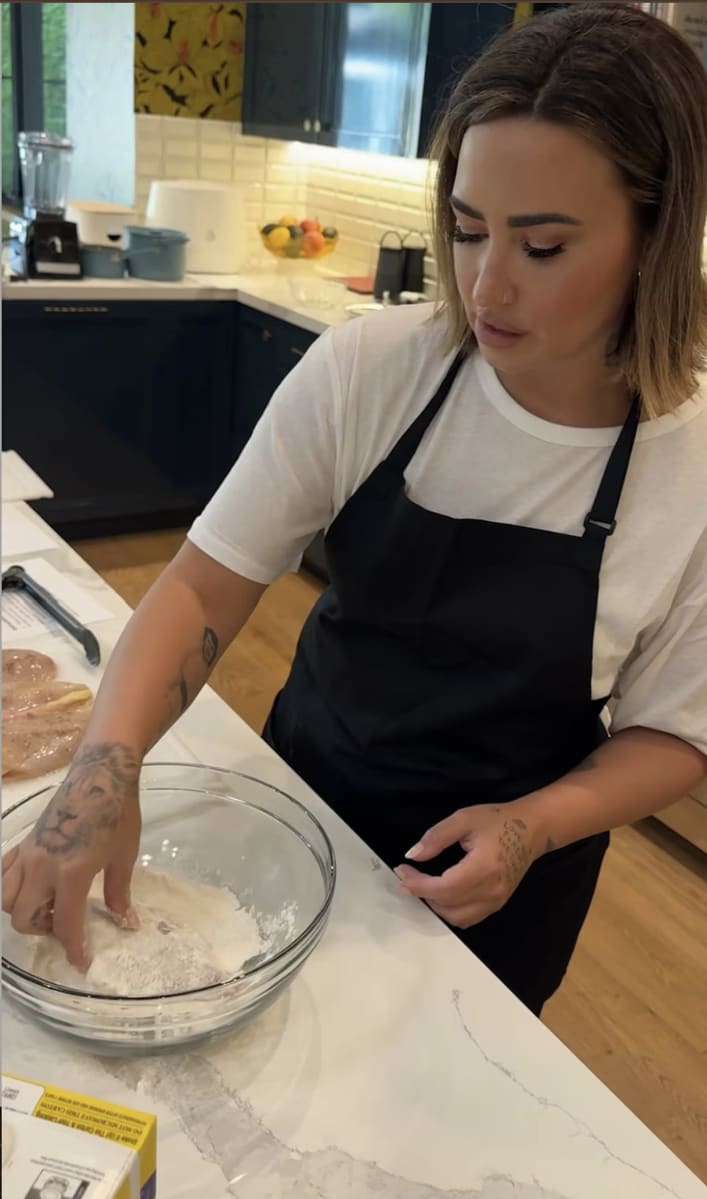 Demi Lovato preparing the chicken