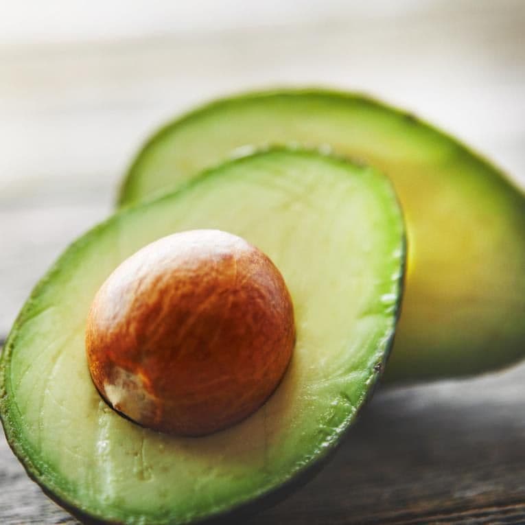 Avocado pieces on a wooden table