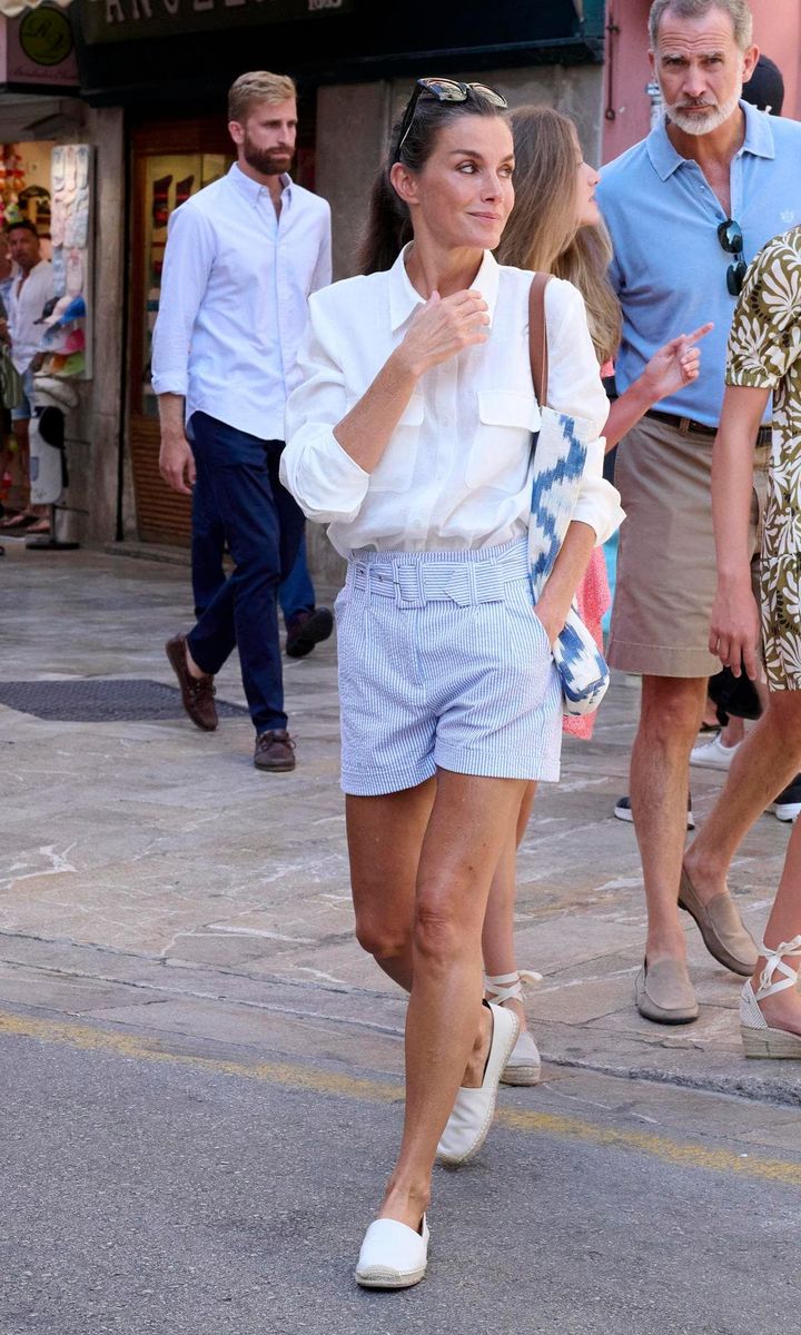 Letizia was dressed in pinstripe shorts and a white button-down shirt for the family outing.