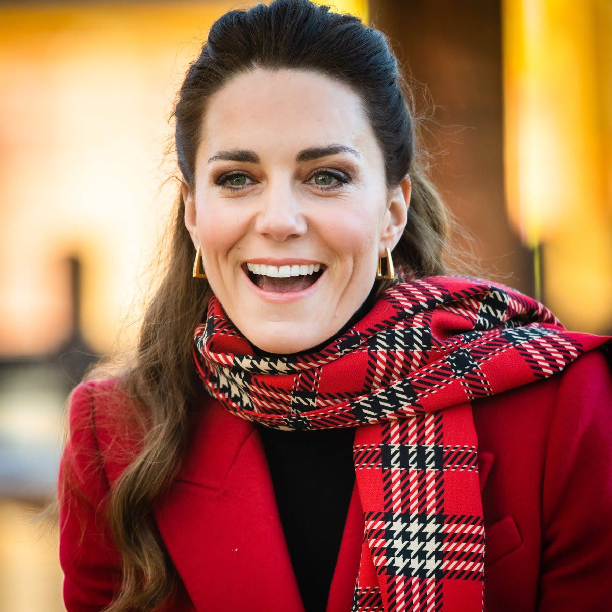 Prince George's mom kept warm with a red tartan scarf.