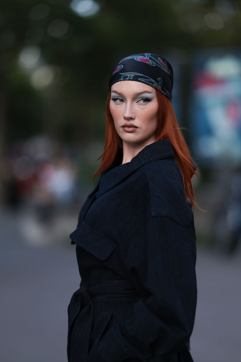 Meredith Duxbury is seen wearing a dark blue headscarf with a blue/pink abstract floral pattern and a dark denim coat with a waist belt from Giorgio Armani outside the Giorgio Armani Prive Show on June 25, 2024, during the Haute Couture Fall/Winter 2024/2025 as part of Paris Fashion Week in Paris, France. 