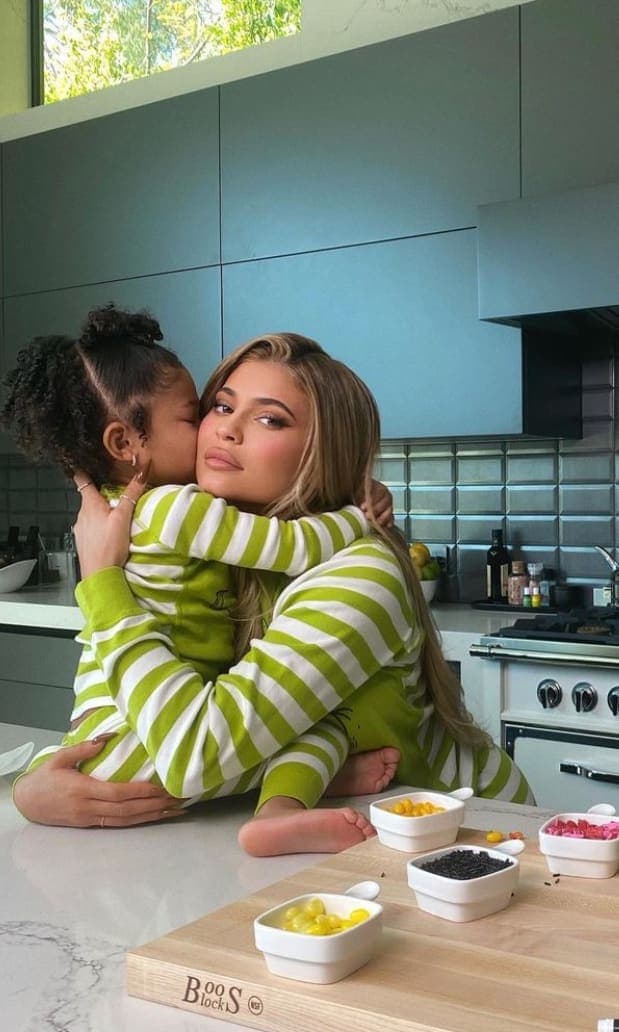 Kylie and Stormi making cookies for the Grinch collection