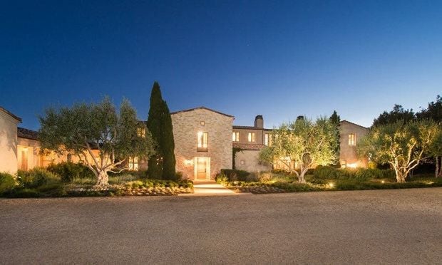 From the outside, this $22.5 million California home looks beautifully lush with planted trees accenting the home's exterior.