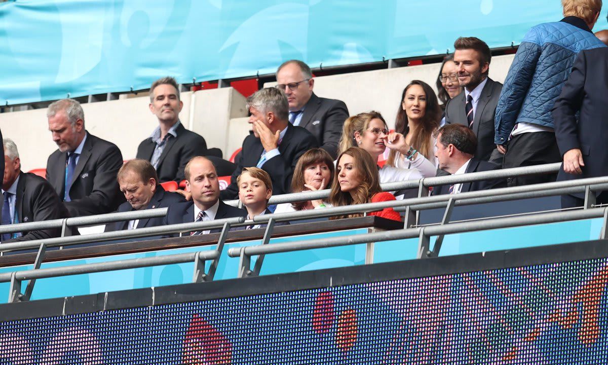 It seems George did not want to miss what was happening on the field as he peered over the railing.