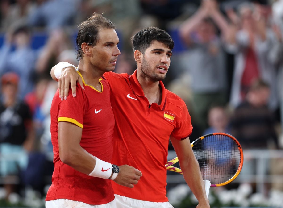 Rafael Nadal (L) and partner Carlos Alcaraz of Team Spain celebrate against Andres Molteni and Maximo Gonzalez of Team Argentina during the Men's Doubles first round match on day one of the Olympic Games Paris 2024 at Roland Garros on July 27, 2024 in Paris, France. (Photo by Clive Brunskill/Getty Images)